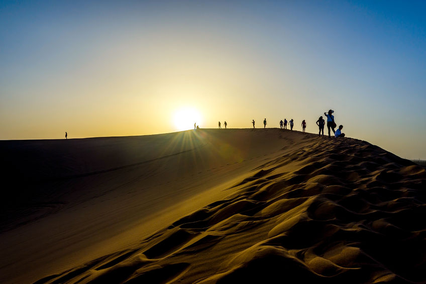 65991016 - silhouette of people on the top of sand dunes gobi desert china